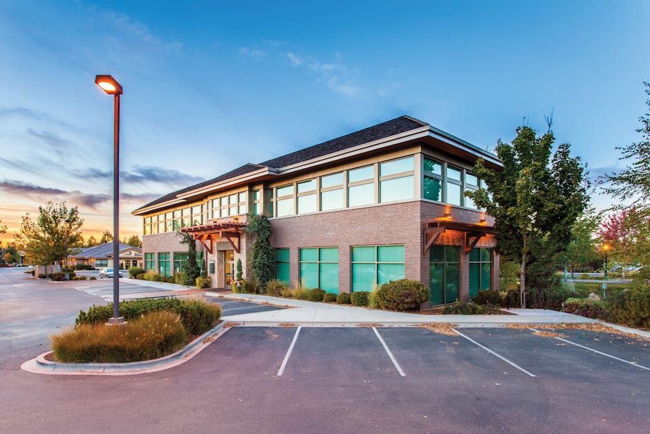 A modern two-story office building in Eagle, ID, captured at sunset with a clear blue sky