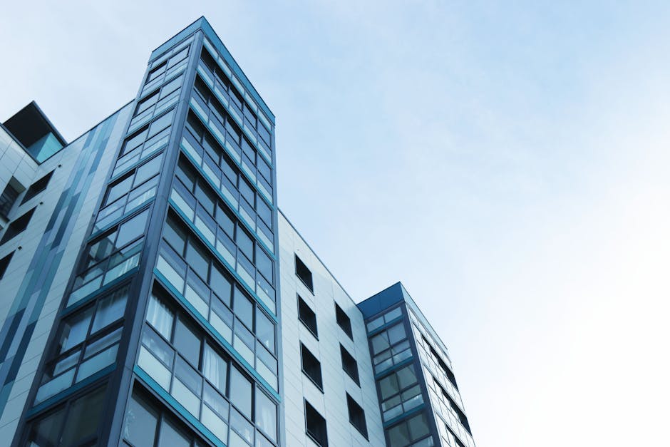 Low-angle view of a modern glass skyscraper against a clear sky in Poole, UK